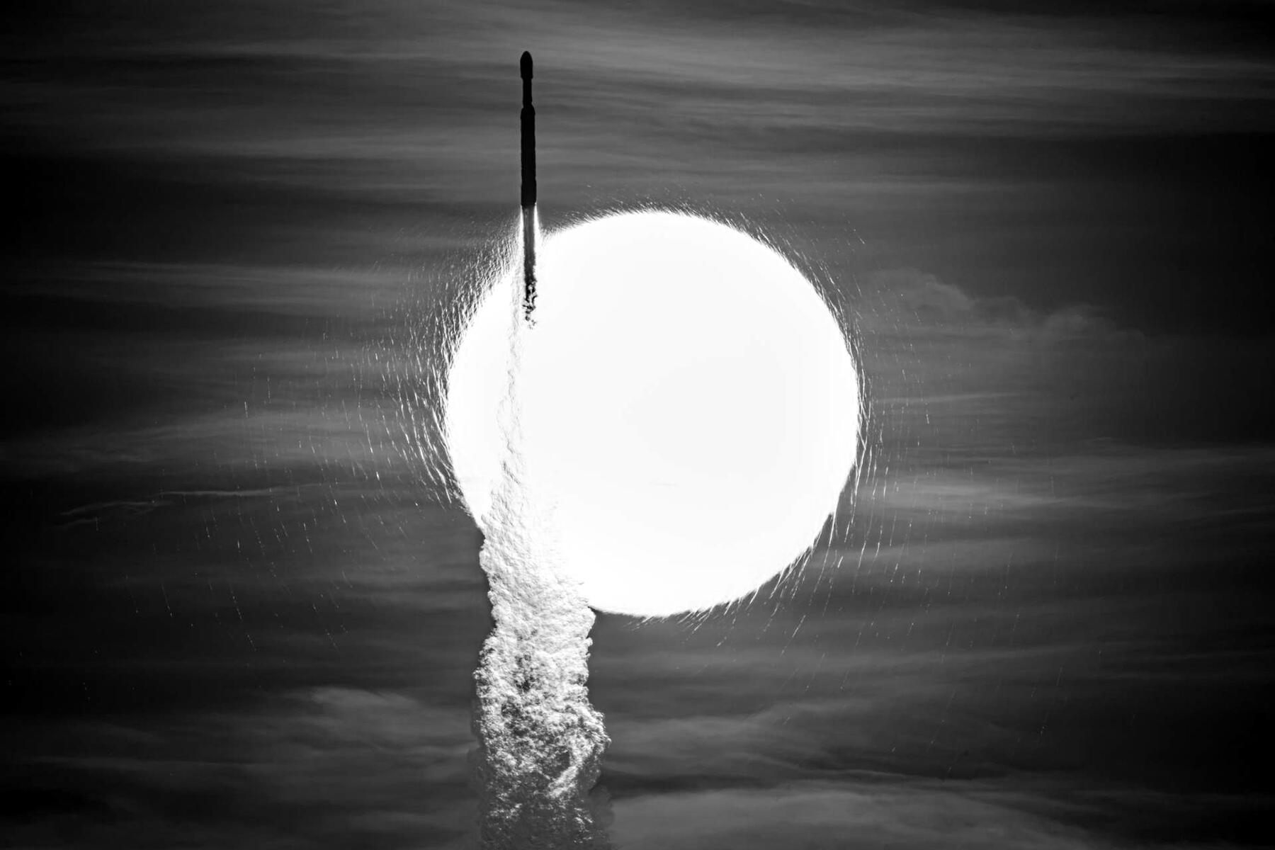 A Falcon Heavy rocket carrying NASA’s Roman Space Telescope crosses in front of the Sun during its morning launch from Kennedy Space Center